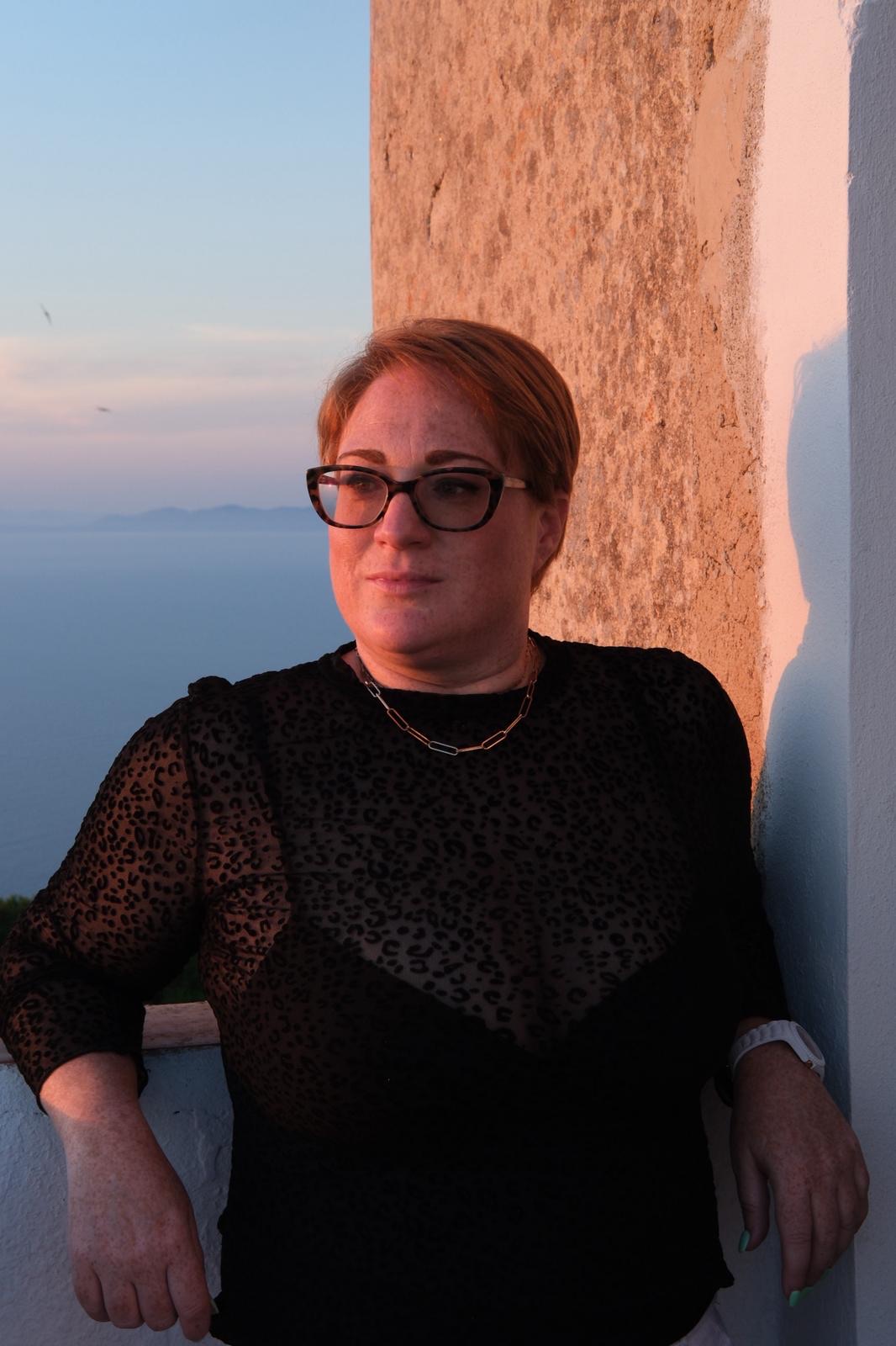 Laura Ansell, founder and head coach of TriSwim Retreats, at sunset by the sea